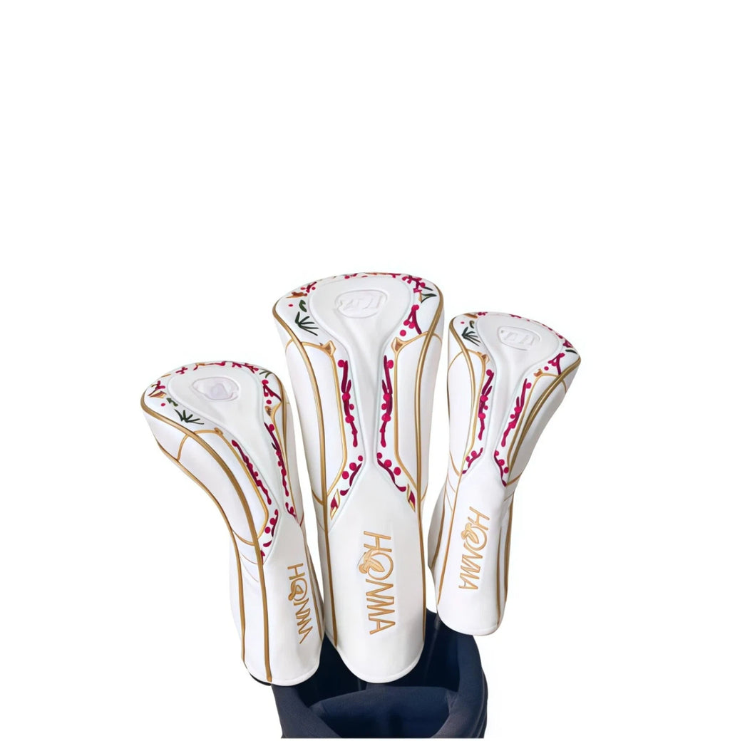 White Honma golf headcover set with red and gold lacquer cherry blossom motif on driver, fairway and hybrid covers