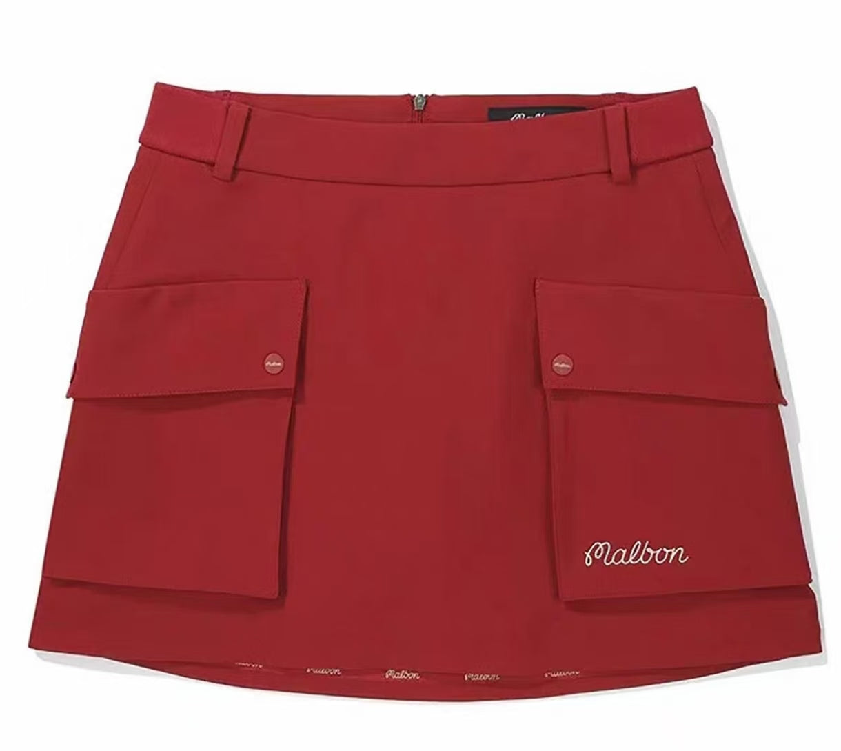 Malbon women's solid pleated golf skort with pockets in Red, branding detail