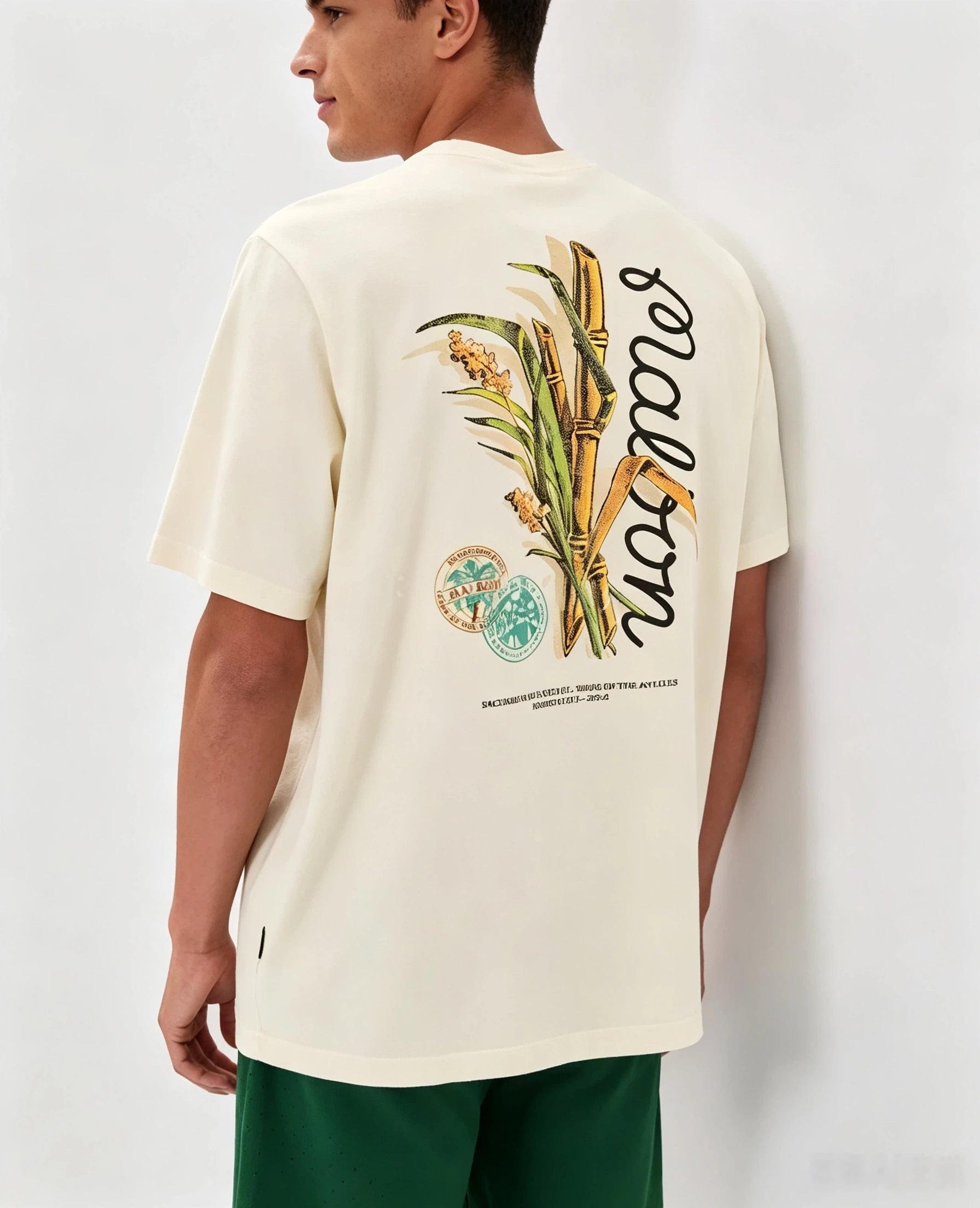 Model wearing Malbon beige graphic T-shirt back view