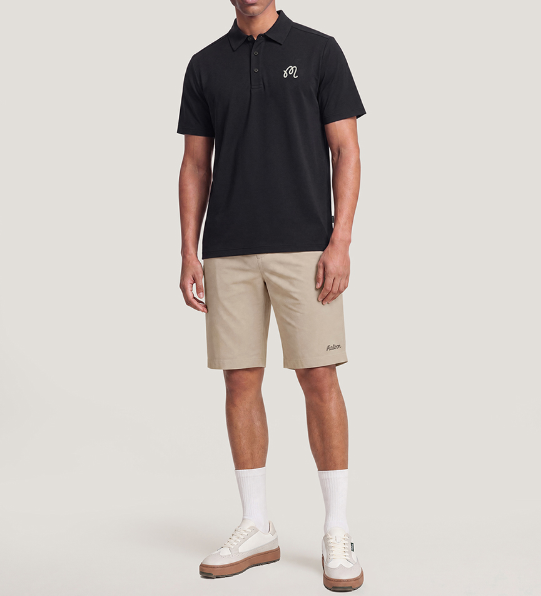 Model wearing Malbon beige golf polo back view