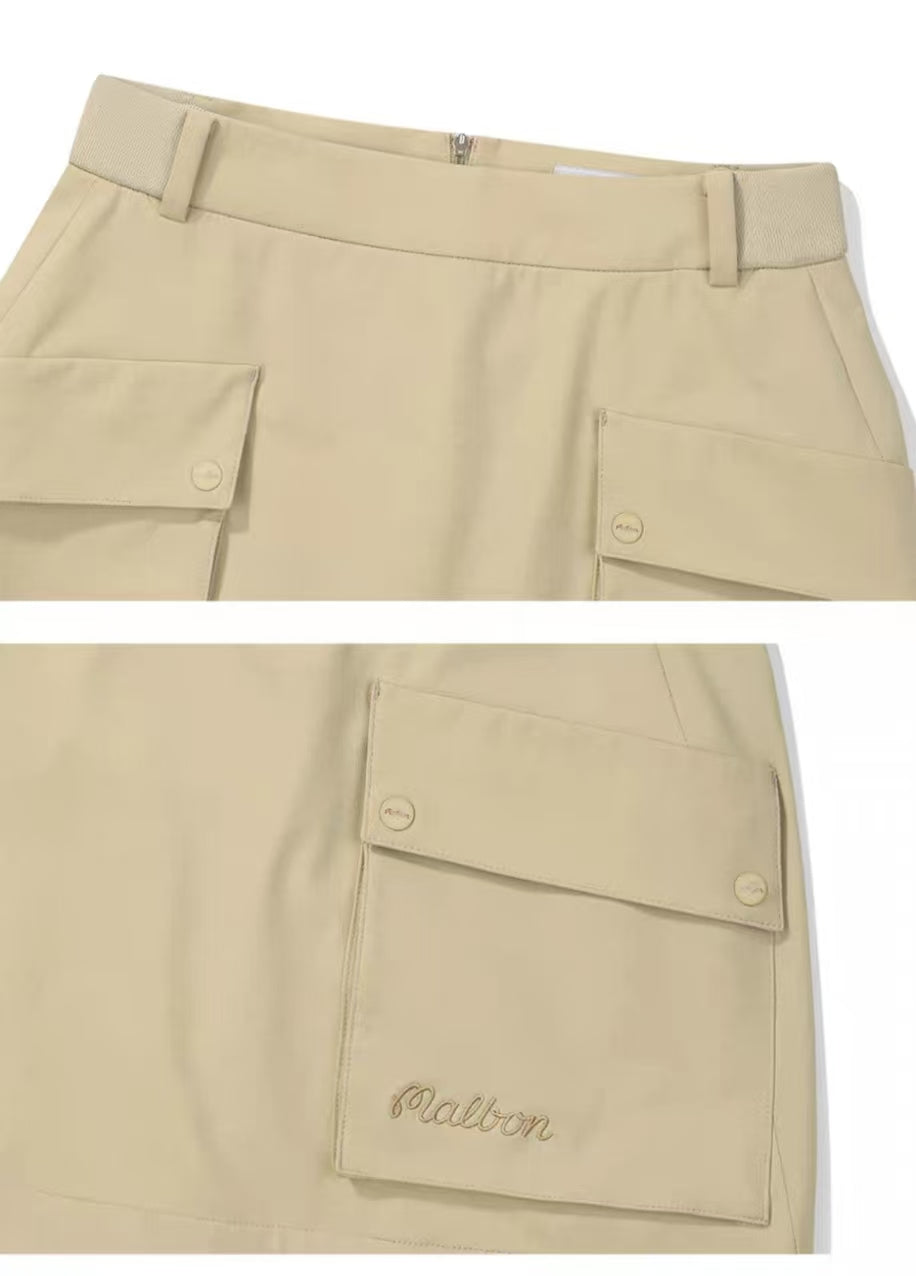 Malbon women's solid pleated golf skort with pockets in Khaki, collar and logo detail