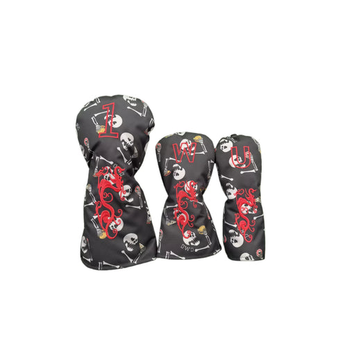 Graffiti flocked golf headcovers set in black featuring red dragon embroidery and white skull bone patterns, labeled with “1”, “W”, “U” for driver, fairway and utility clubs.