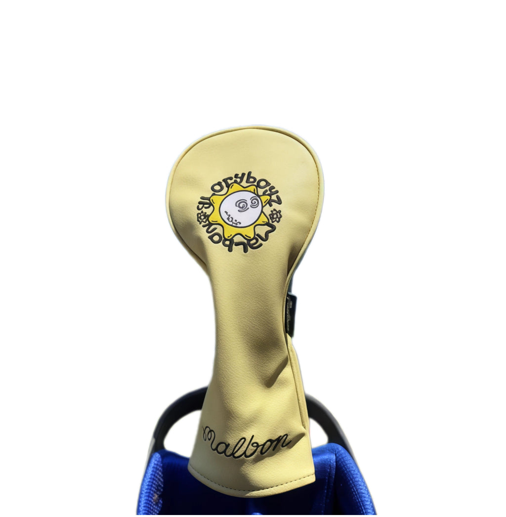 Beige Malbon Golf driver headcover with a minimalist sunflower design and circular "Malbon" logo — durable, lightweight protection for your driver with a cheerful, modern aesthetic.
