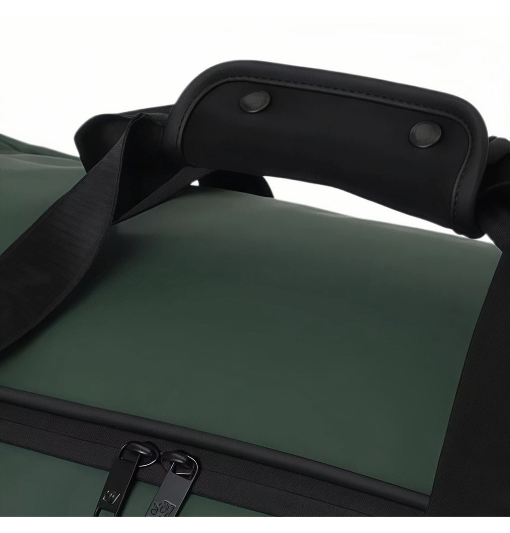 Close-up of padded top handle and dual zipper pulls on Malbon Golf duffle bag, emphasizing ergonomic grip and secure closure design