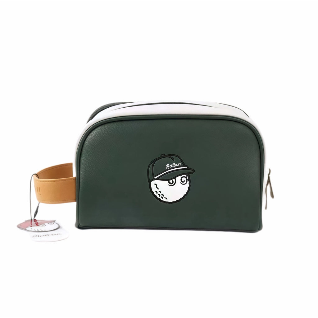 Front view of Malbon Golf Buckets pouch in forest green featuring embroidered golf ball mascot wearing black cap, tan leather handle, and official brand tag for authenticity