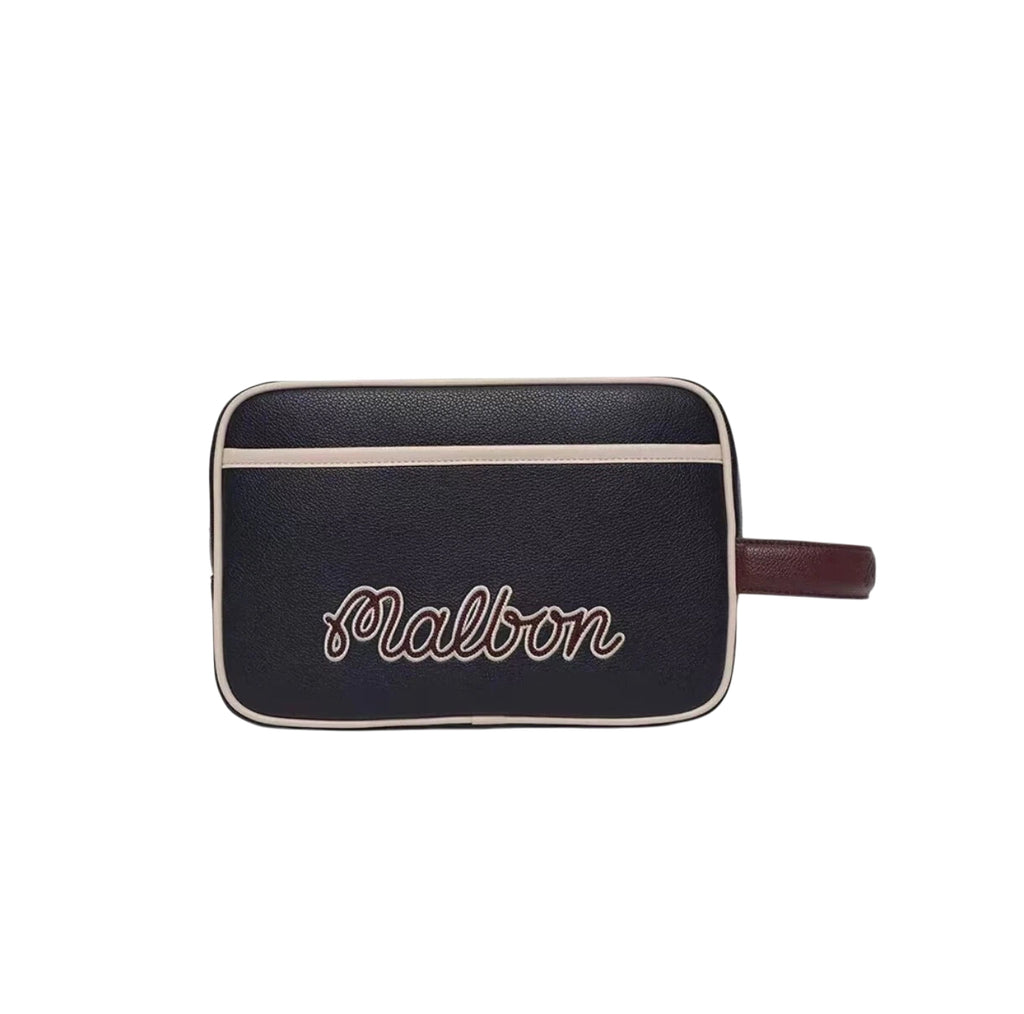 Front view of the black Malbon golf tote bag featuring a playful golf ball mascot wearing a hat with "Malbon" branding. Vintage-style handbag for golf lifestyle.
