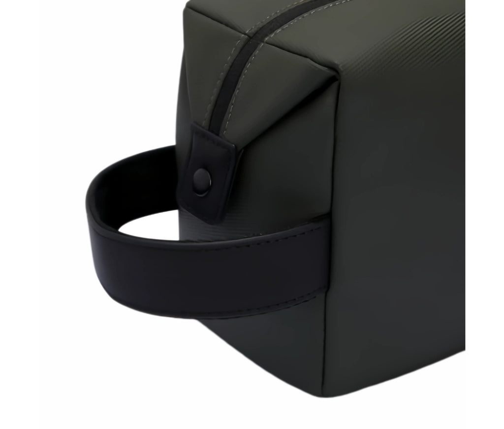  Close-up of Malbon Golf mini handbag wrist strap with reinforced stitching and snap button attachment, showcasing durable construction and high-quality finish