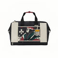 Front view of Malbon Golf Poker King duffle bag featuring bold King of Clubs design in red, green, and black, with 3D crown charm accent and dual-tone black and cream PU leather construction
