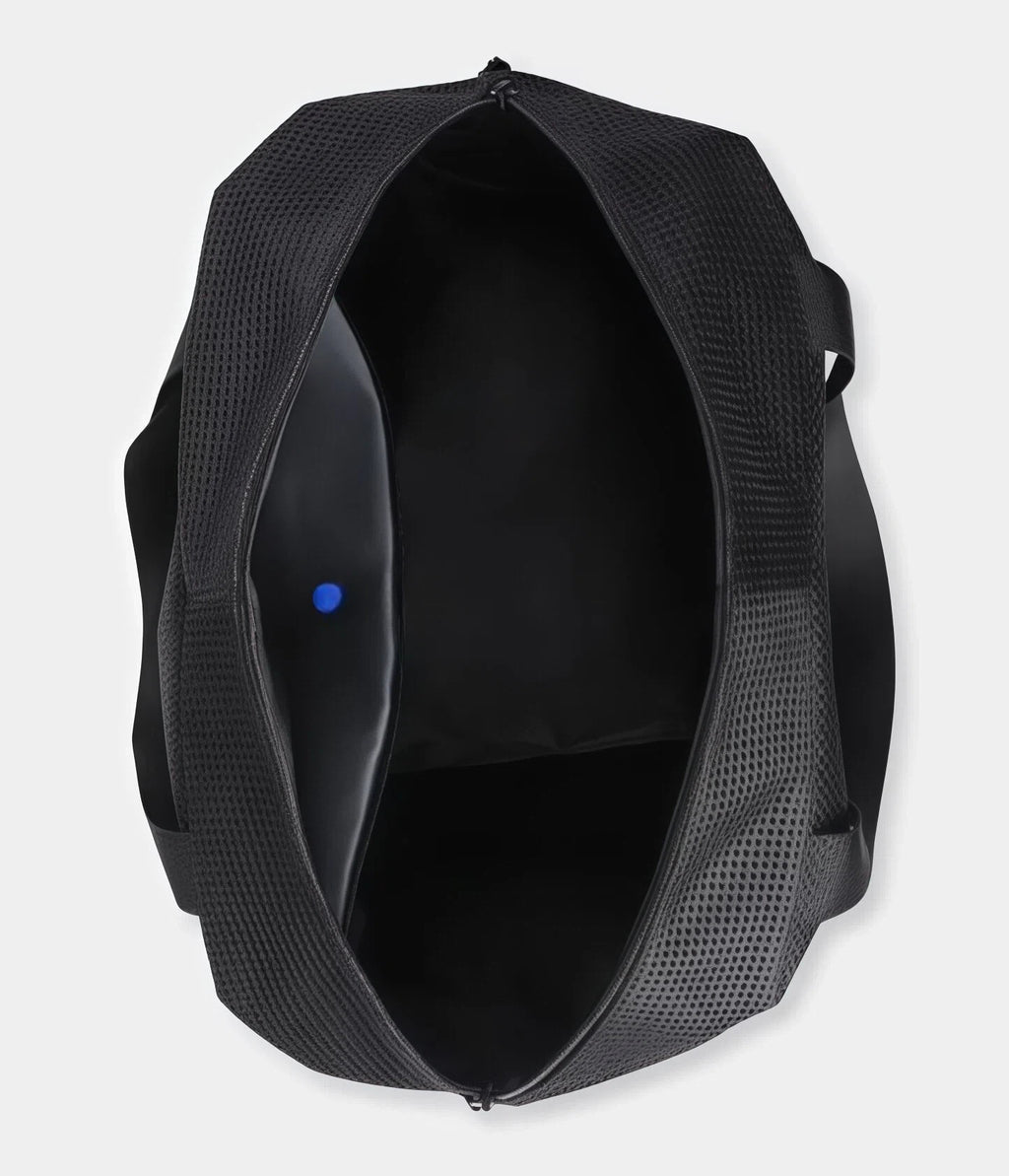 Top-down view of the Mizuno gym duffel bag interior showing a large, ventilated main compartment with mesh lining and reinforced structure for maximum capacity.
