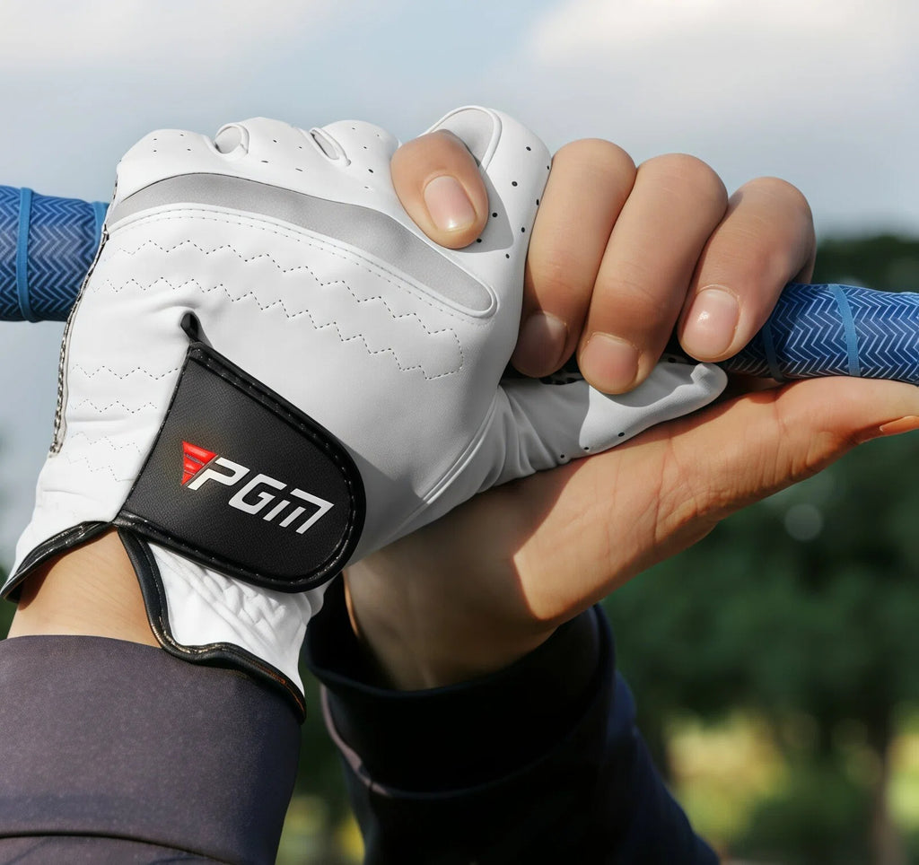 A golfer wearing the white PGM leather glove demonstrates a secure interlocking grip on a golf club. The glove provides a comfortable and stable feel, enhancing performance and control during a swing.