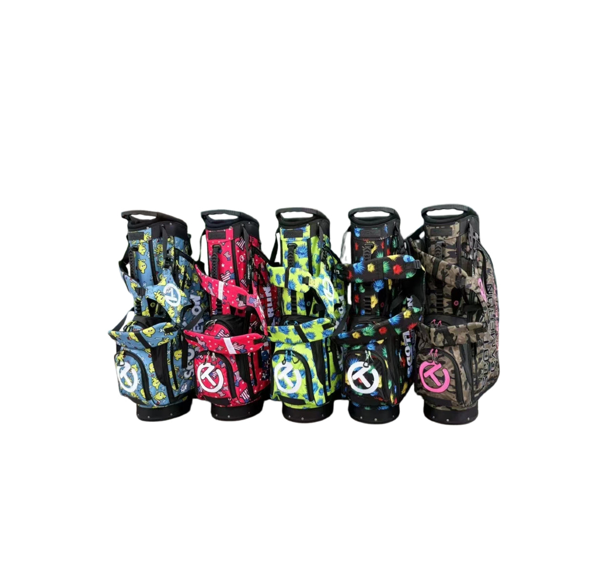 A front view showcasing a collection of five Scotty Cameron Junior Stand Bags. The lineup includes the Camo-Pink bag alongside other vibrant patterns like multi-color pineapples, yellow chicks, and red stars.