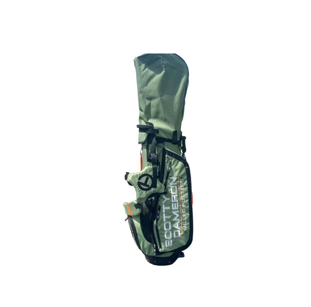 Front view of the Scotty Cameron Pathfinder Stand Bag in Green, featuring the Circle T logo, "SCOTTY CAMERON MILLED PUTTERS" text, and orange accents on a sleek, lightweight design.