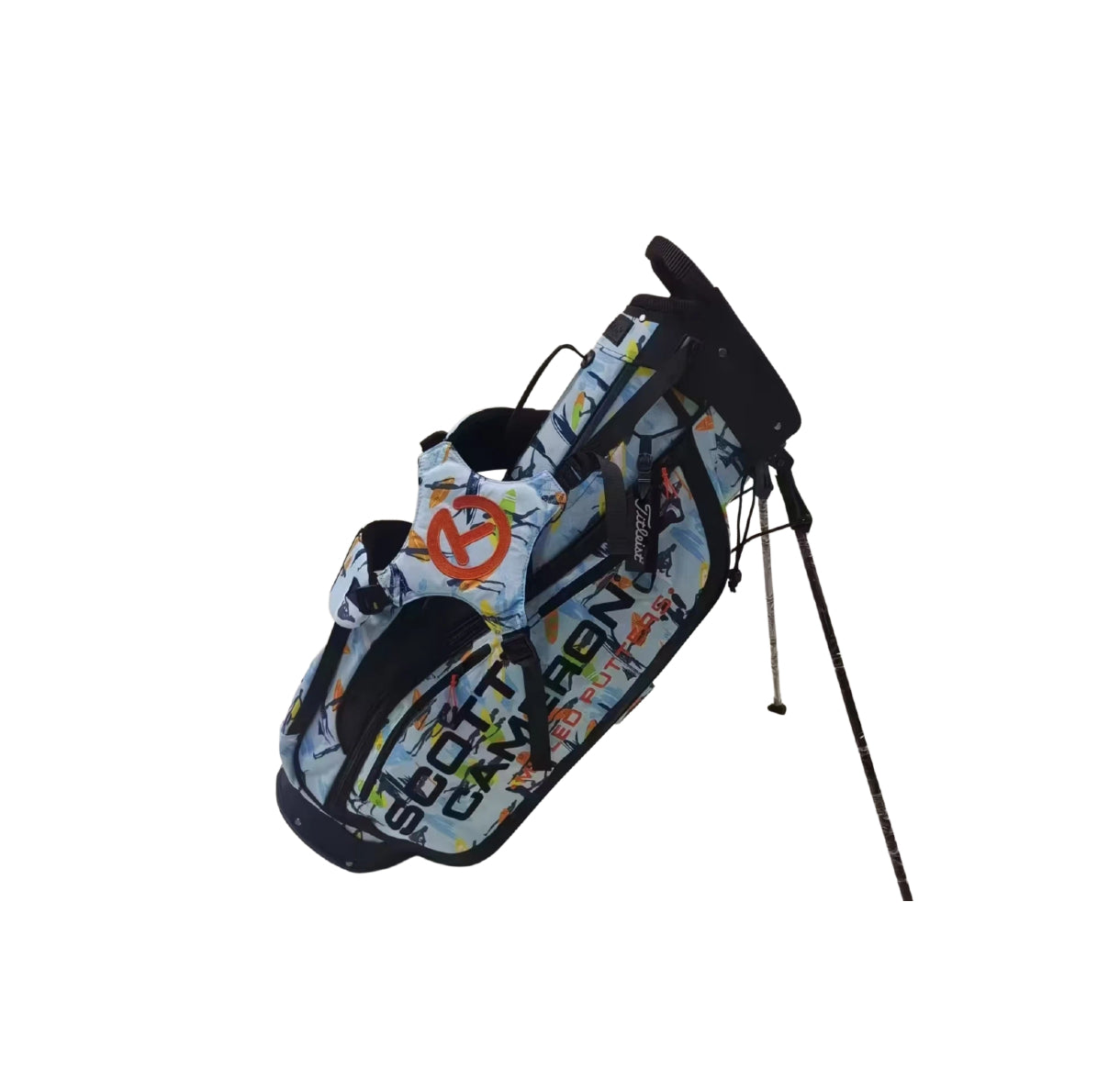 Angled view of the Scotty Cameron Pathfinder Surfer-Blue stand bag with dual legs extended, showcasing its lightweight design, vibrant surf-themed print, and bold orange Circle T logo on the side pocket.