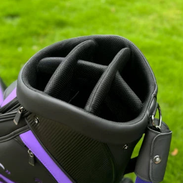 A close-up top-down view of the Scotty Cameron golf bag, revealing the 6-way top divider system. The black, padded dividers are designed to organize and protect golf clubs, preventing them from clattering during transport.
