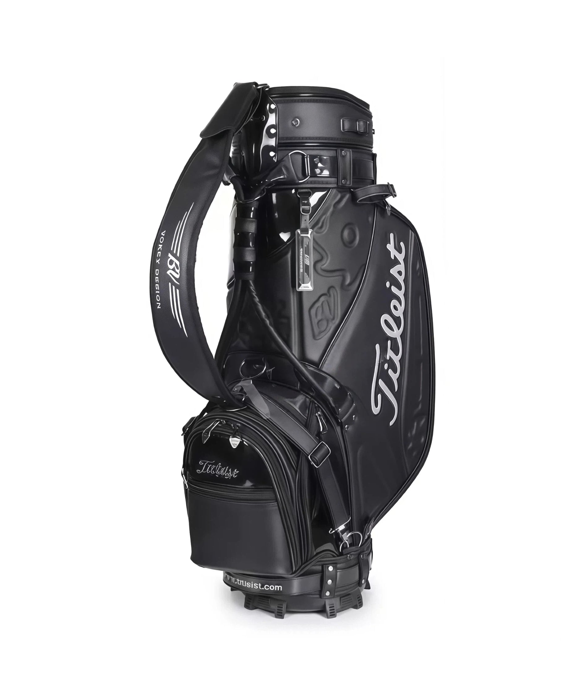 Full view of the Titleist Heritage Cart Bag in black glossy finish. Features the "Titleist" script logo in silver, padded shoulder strap with "Vokey Design" text, and multiple zippered compartments. Built for durability and elegance.