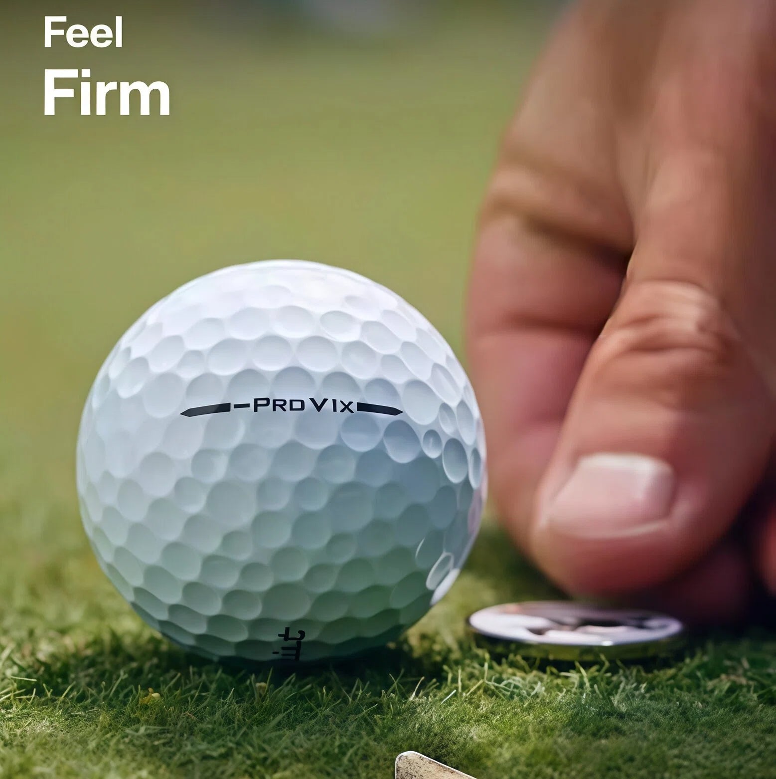 Close-up of a Titleist Pro V1x Left Dash golf ball on grass, highlighting its firm feel and detailed dimple pattern, with a hand and coin for scale, emphasizing its premium construction and performance.