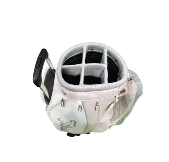 Top-down view of the Titleist Waterproof Stand Golf Bag showing its 5-way top divider system, durable fabric, and light pink and mint color scheme with the Titleist logo on the side.