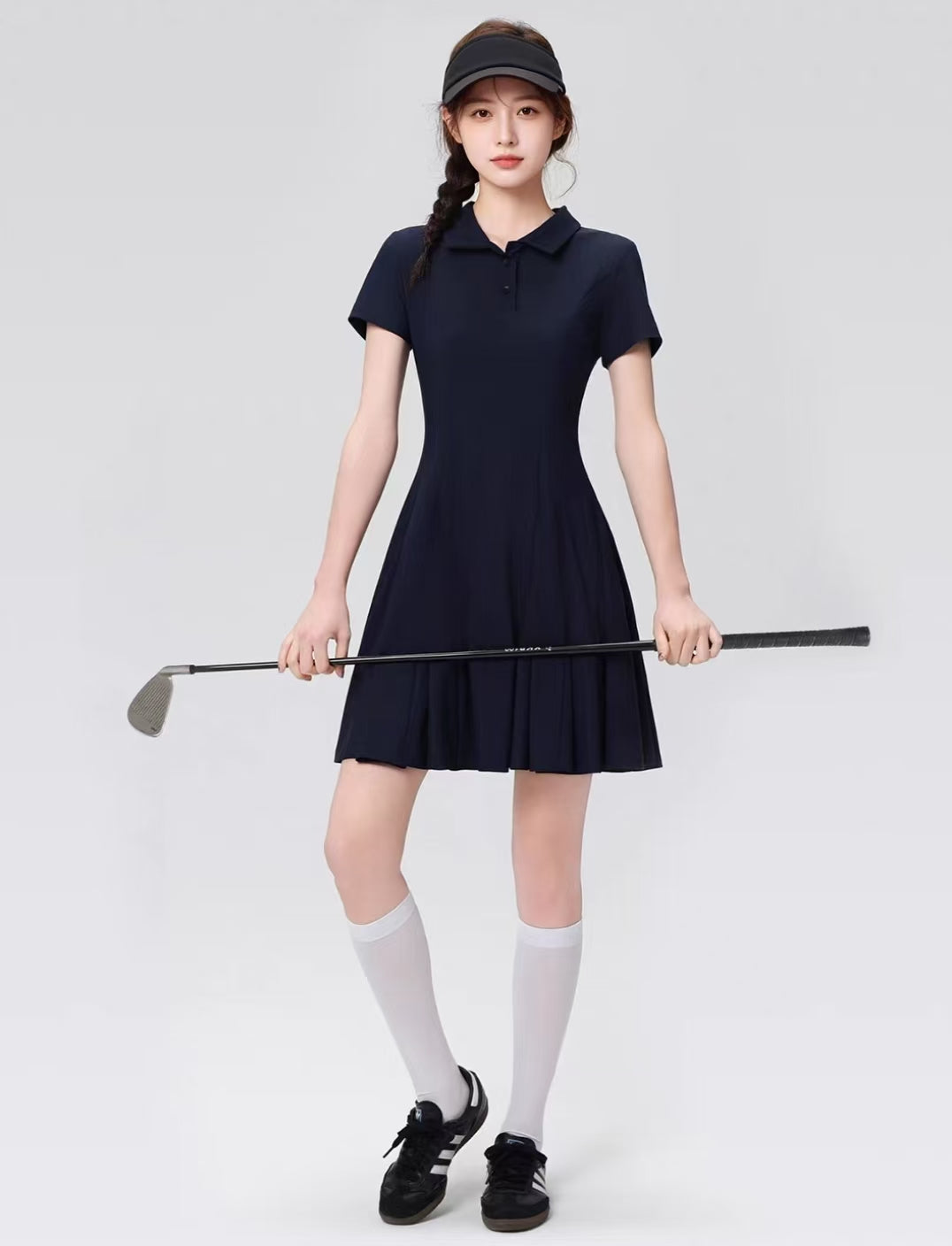 OZERO Navy waist-cinched golf dress side view on model